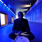 Tony Allen (Bernard Benant) in blue sitting with snare drum small
