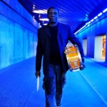 Tony Allen (Bernard Benant) in blue walking with drum