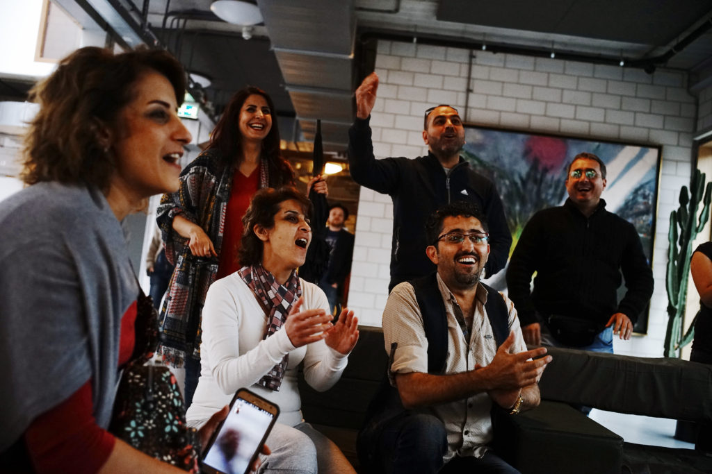 Choir members burst into song, Amsterdam by Ayman Oghanna