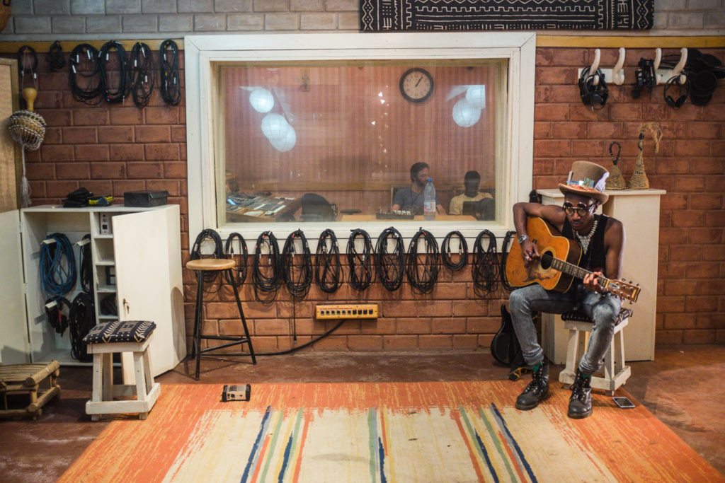 Seye strumming guitar in Bamako's Bogalan studio, used to record Songhoy Blues photo by N.Zinner